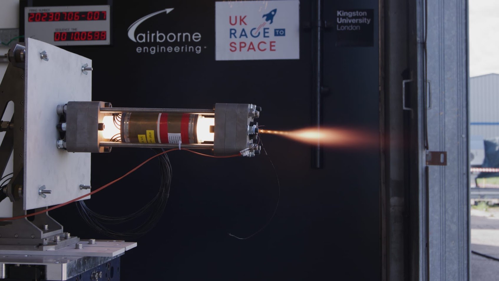 MACAW hybrid rocket motor undergoing a test firing with sensing research hardware fitted